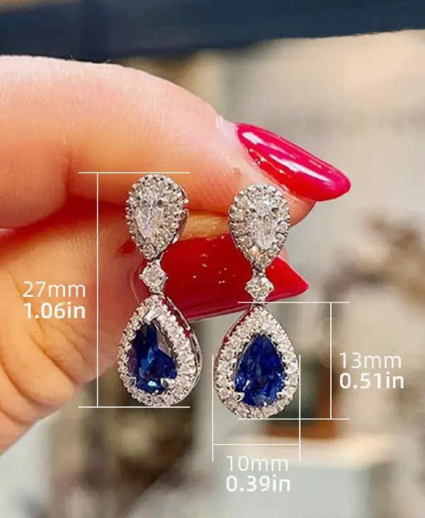 paire de boucles d'oreilles pendantes élégantes et stylées avec zirconium cubique bleu foncé brillant L’Art des Vêtements